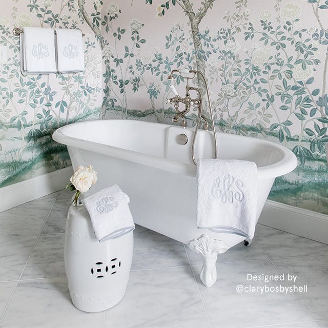 A white bathroom decorated with weezie's light grey monogrammed bath towel.