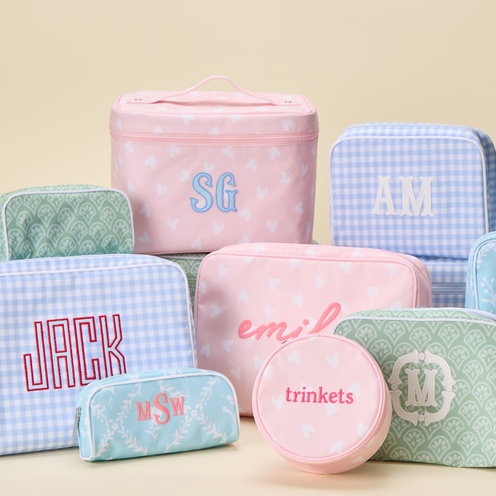 A group of patterned Weezie bags in various sizes, shapes, and designs, all personalized with colorful embroidery.