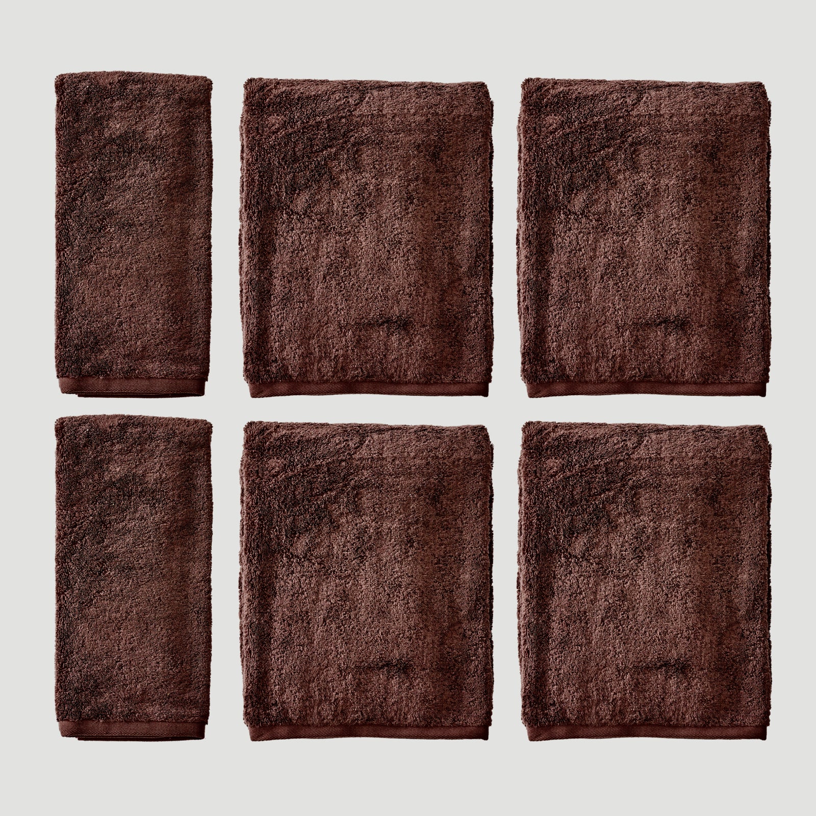 Two dark brown plush hand towels and four matching bath towels arranged in a 2x3 grid on a light gray background.