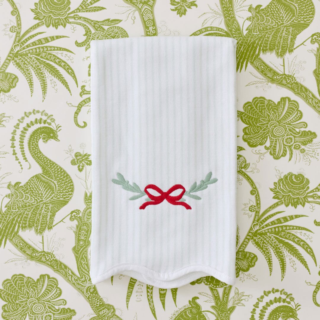 Kitchen towel in Garland with red bow and greenery embroidery on a green botanical print