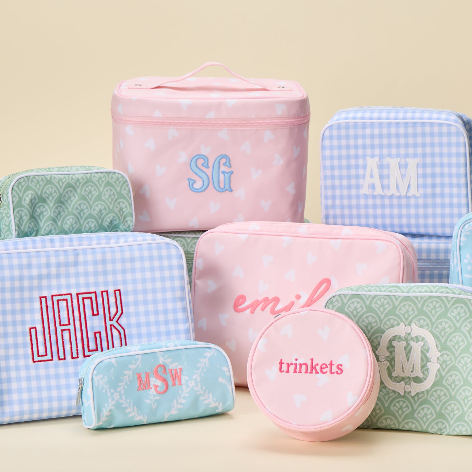 A collection of patterned Weezie bags, including a medium patterned toiletry bag, all personalized with custom embroidery.