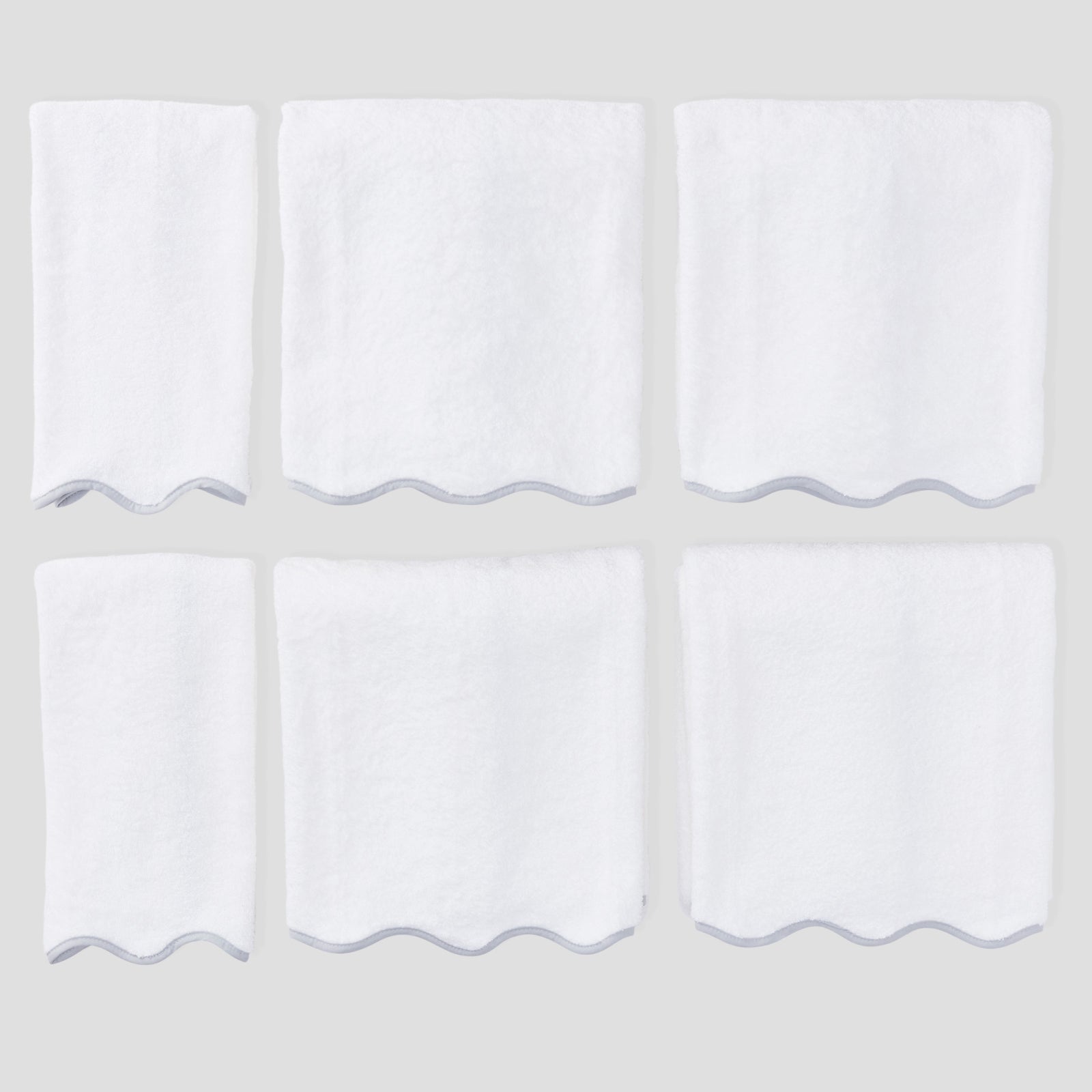 Scallop Starter Pack in Grey on White, six folded white towels with grey scalloped edges.