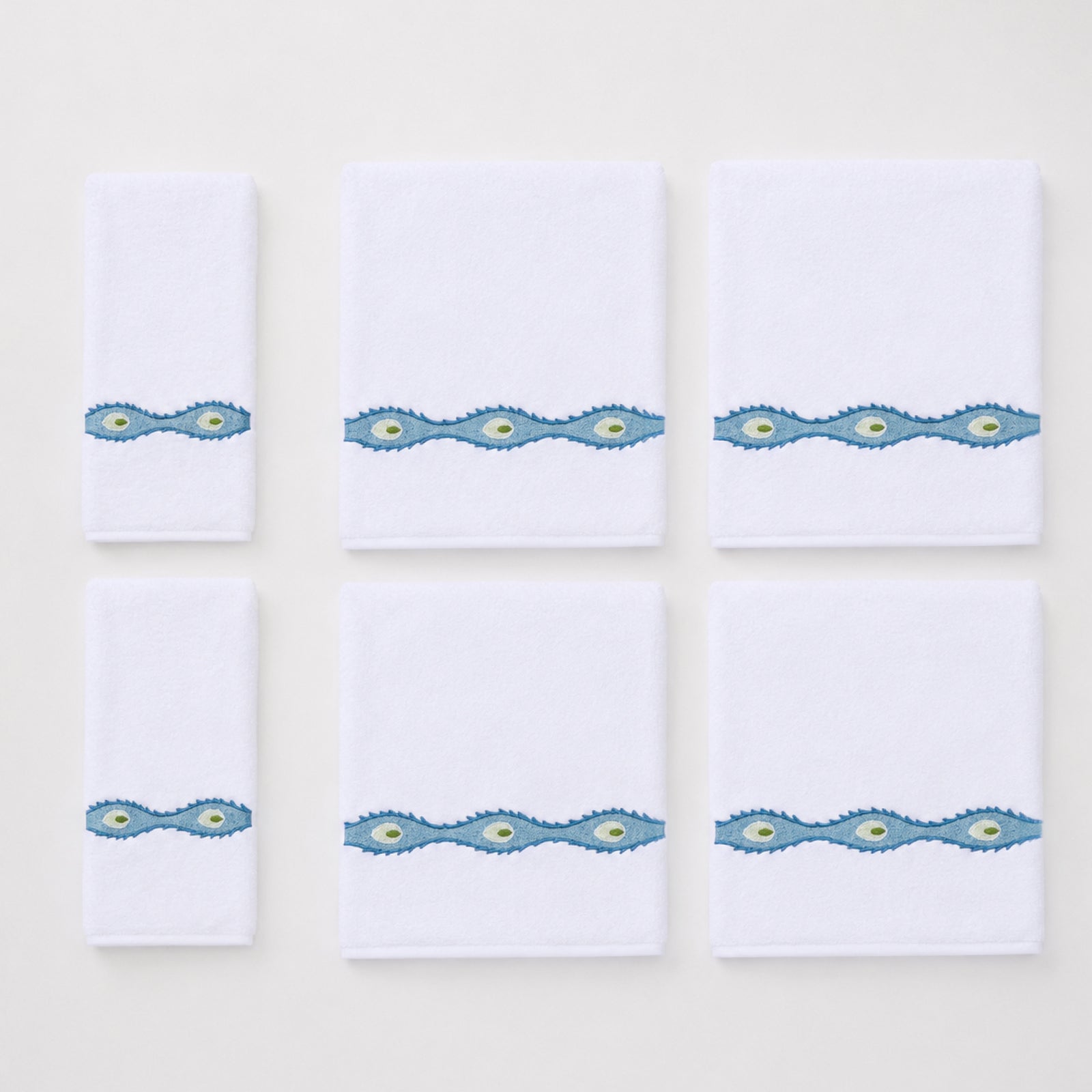 Set of four bath and two hand towels featuring a wavy blue and green embroidered floral motif.