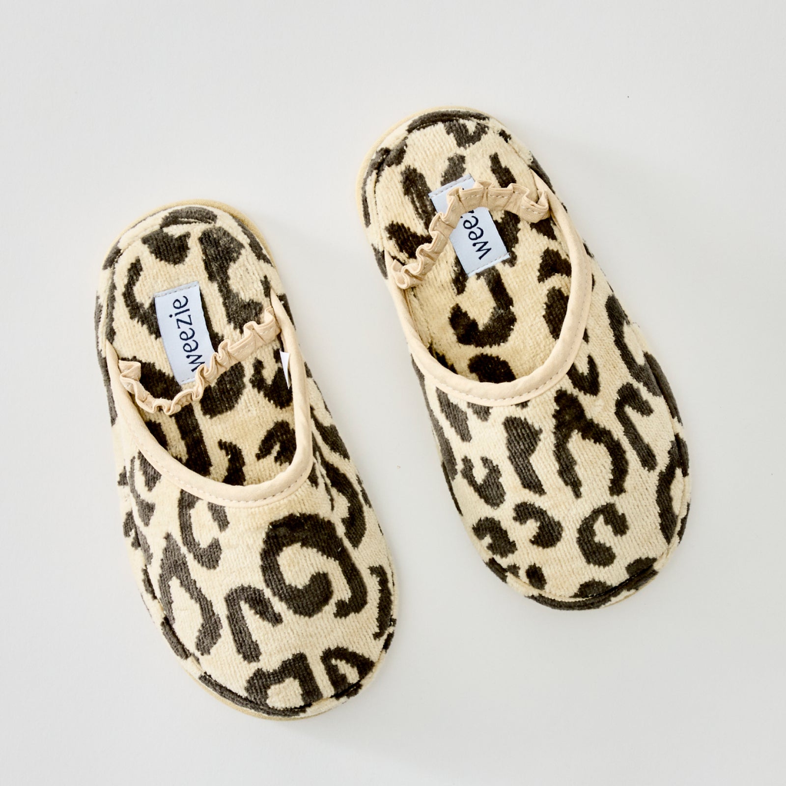 Fluffy leopard slippers with a ruffled elastic strap.