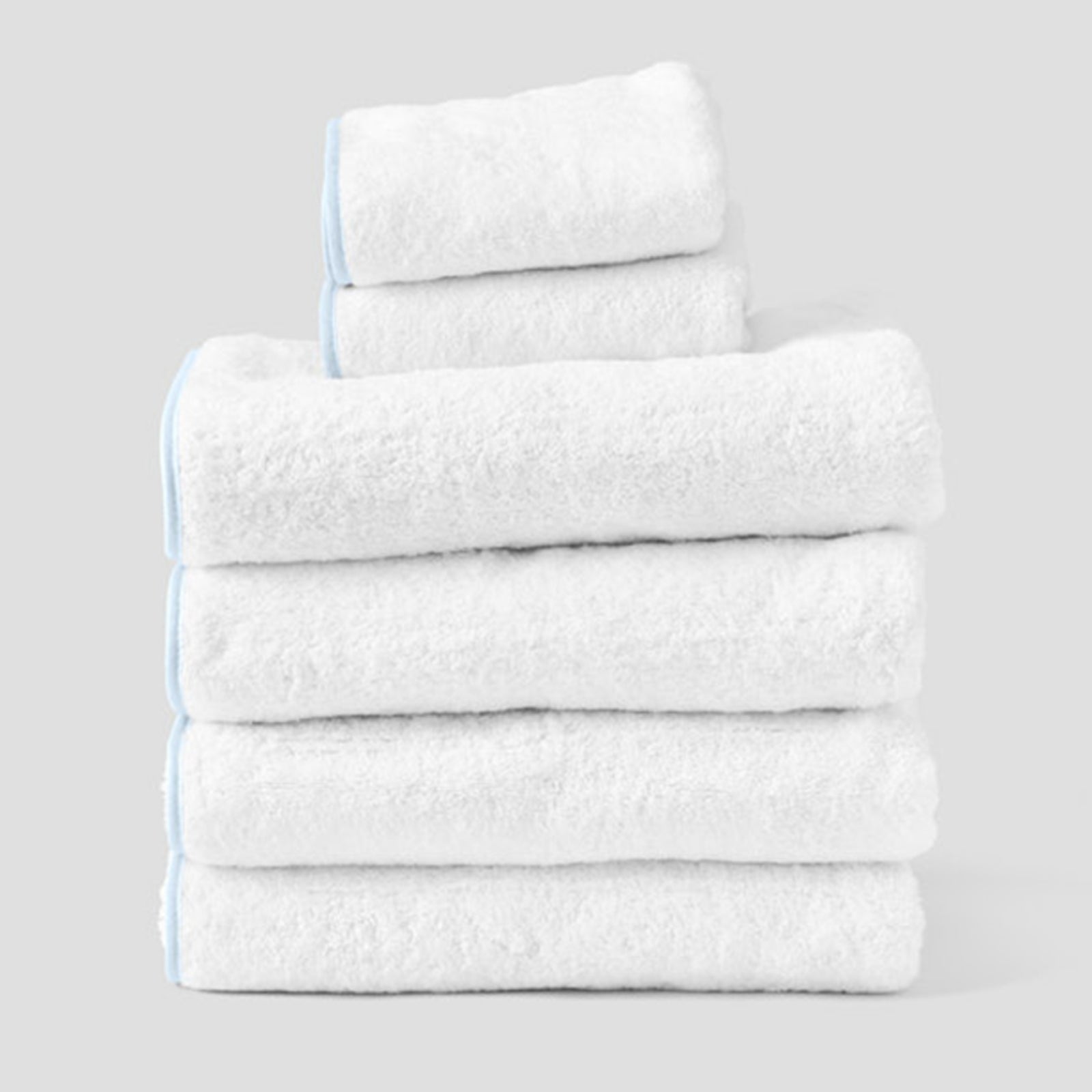 Signature Starter Pack in Light Blue on White, a folded stack of white towels with light blue piping.