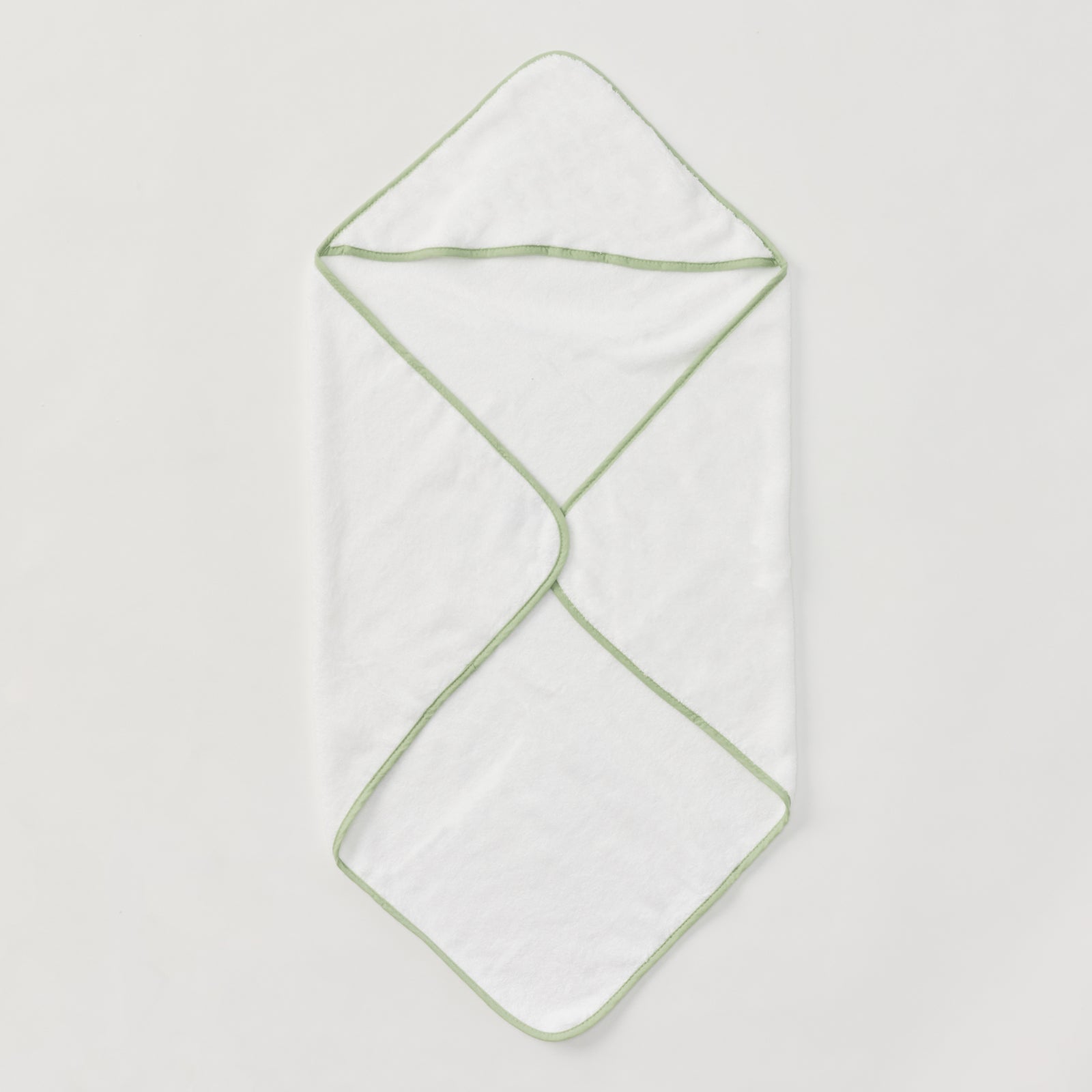 White baby hooded towel with matcha green piping, folded flat.