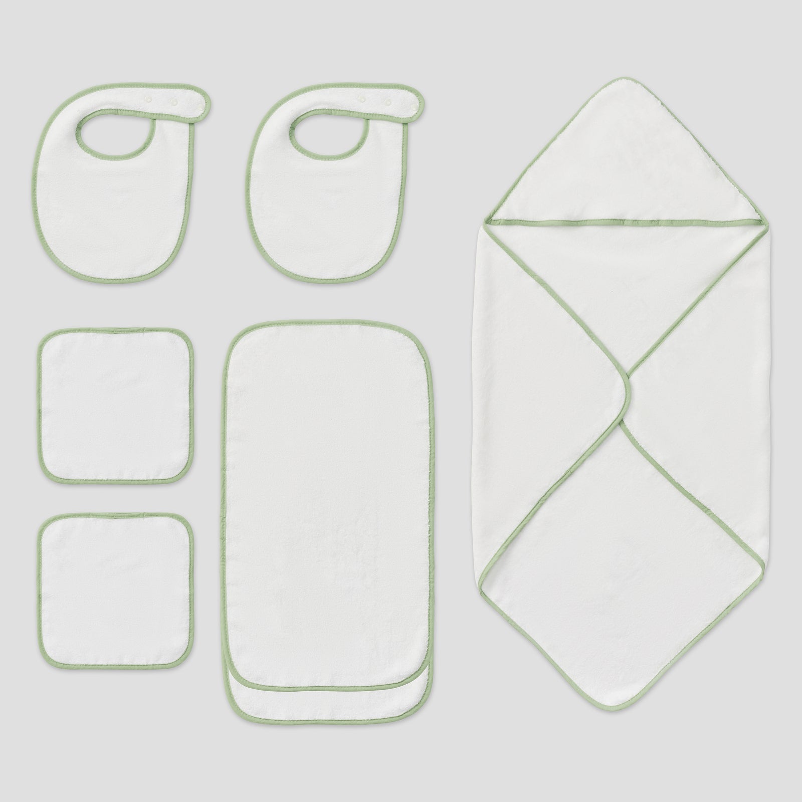 White baby hooded towel, two bibs, two burp cloths, and two washcloths with matcha green trim.