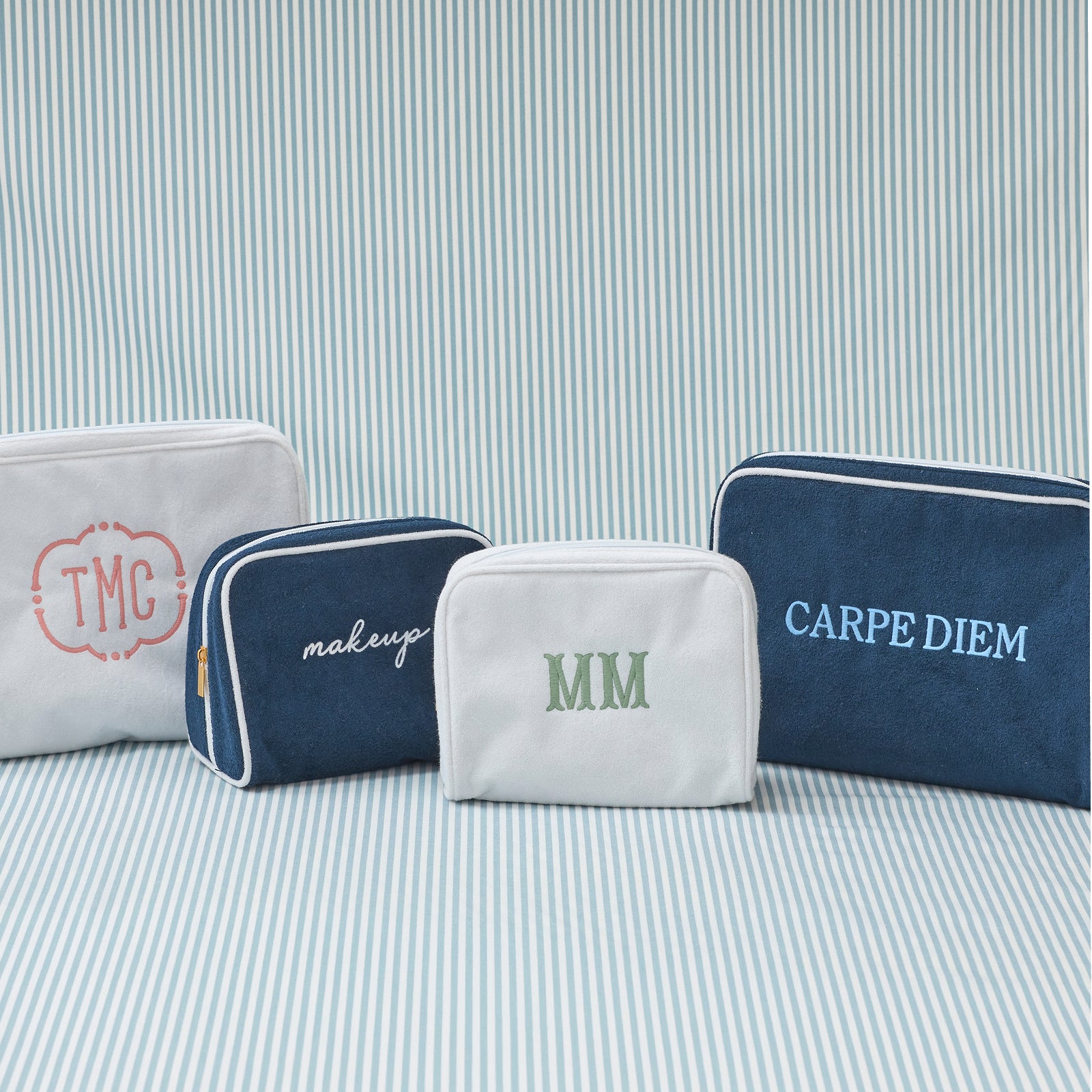 Small Signature Toiletry Bag in Navy and White, both colorways with sample monograms.