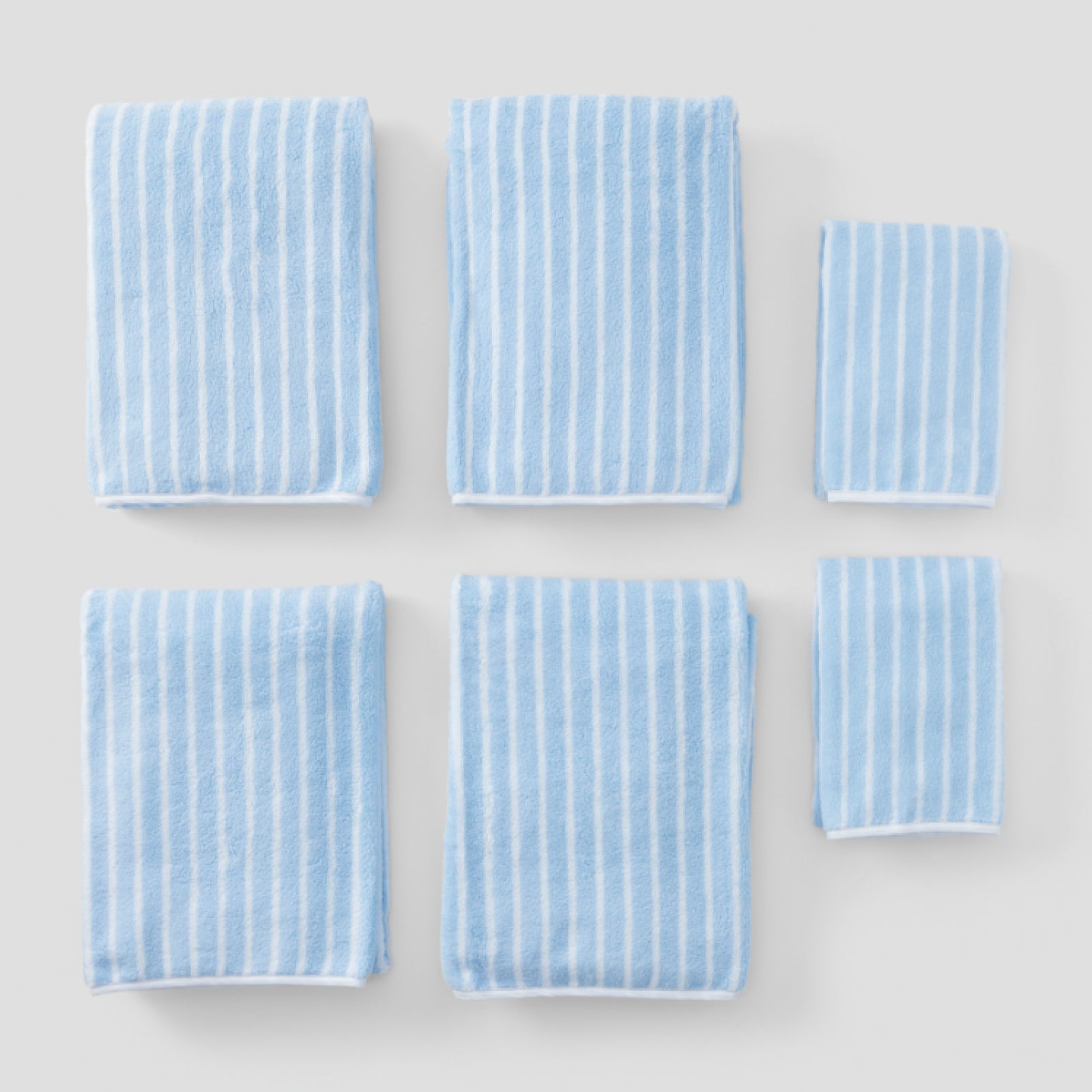 Striped Starter Pack in Parker Blue, six folded towels in light blue and white stripes.