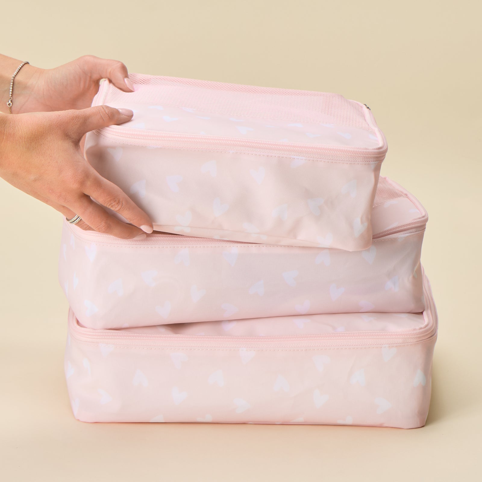 Packing cube bundle in pink heart print featuring lightweight travel organizers with breathable mesh tops in multiple sizes