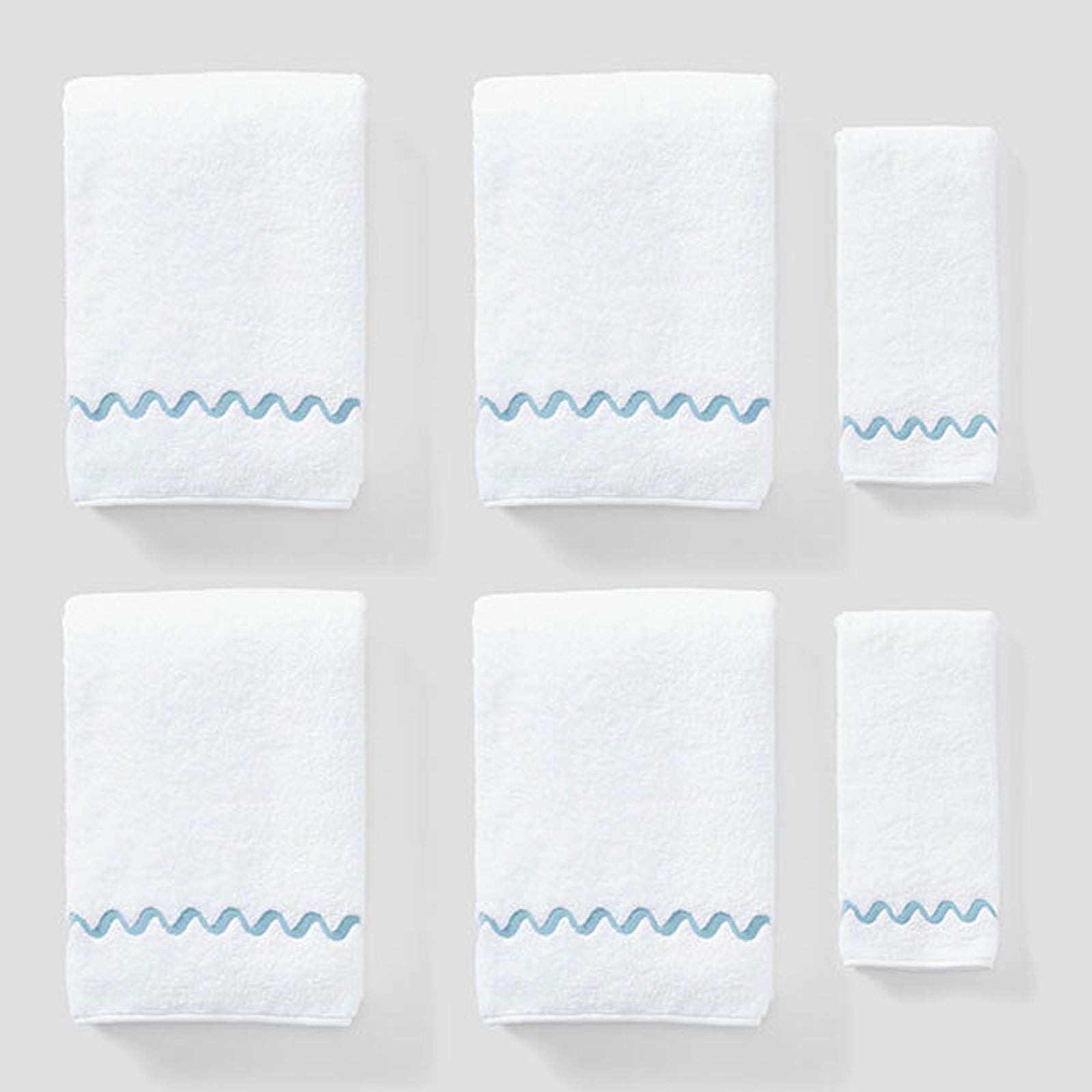 Wave Embroidered Starter Pack in Spa Blue Wave, six white towels with blue wave embroidery.