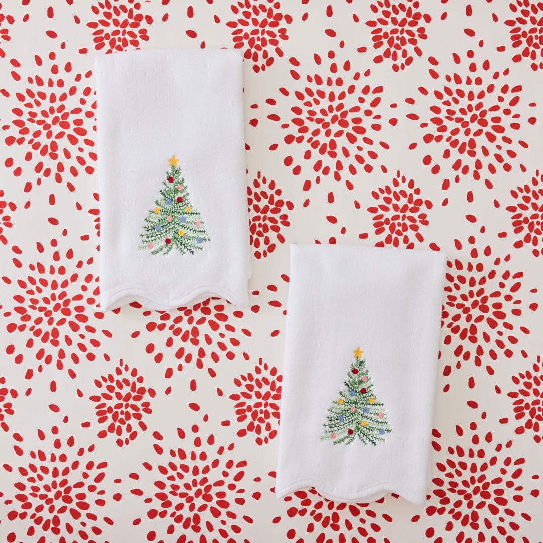 Pair of folded white Holiday Tree powder bath towels with embroidered Christmas trees on a red and cream floral print
