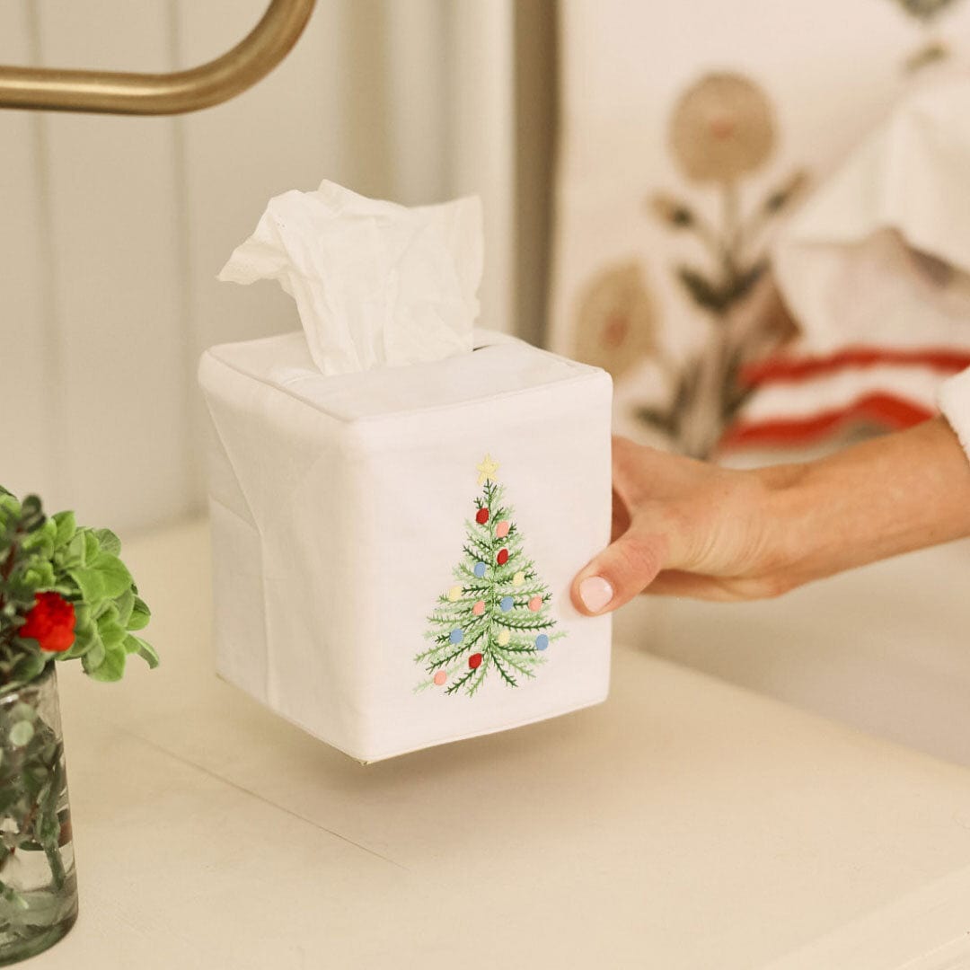 Holiday Tree cotton tissue box cover on a bathroom vanity beside a gold faucet and a small vase of greenery