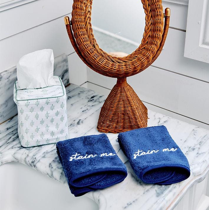 Light Green Leaf cotton tissue box cover on a vanity beside a rattan mirror and navy embroidered hand towels