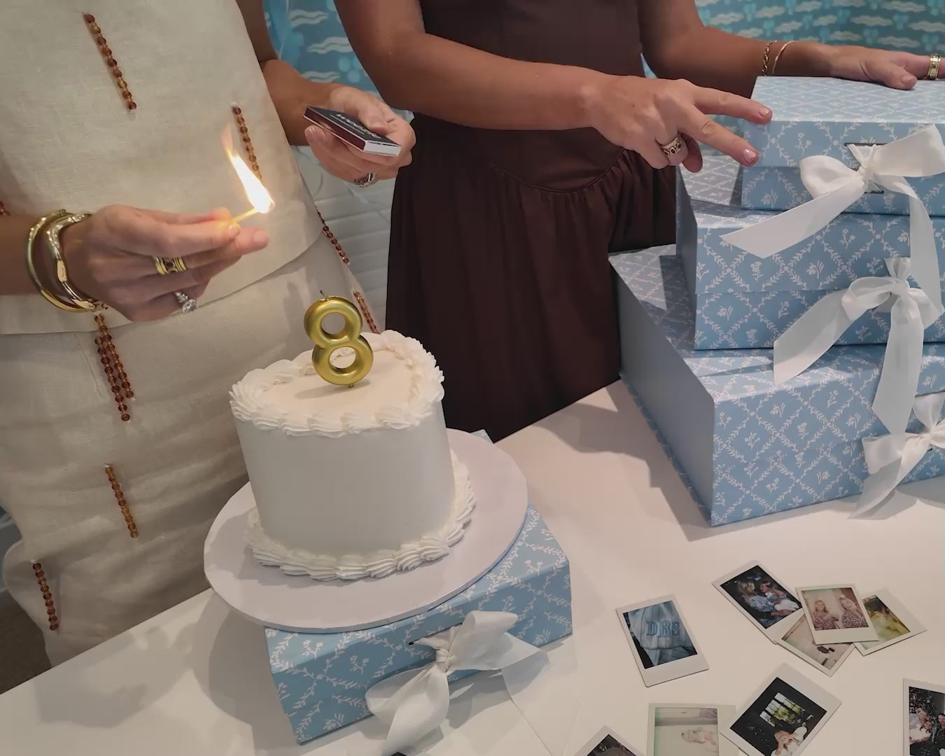 Weezie founders Liz and Lindsey lighting an 8th birthday candle and blowing it out. 