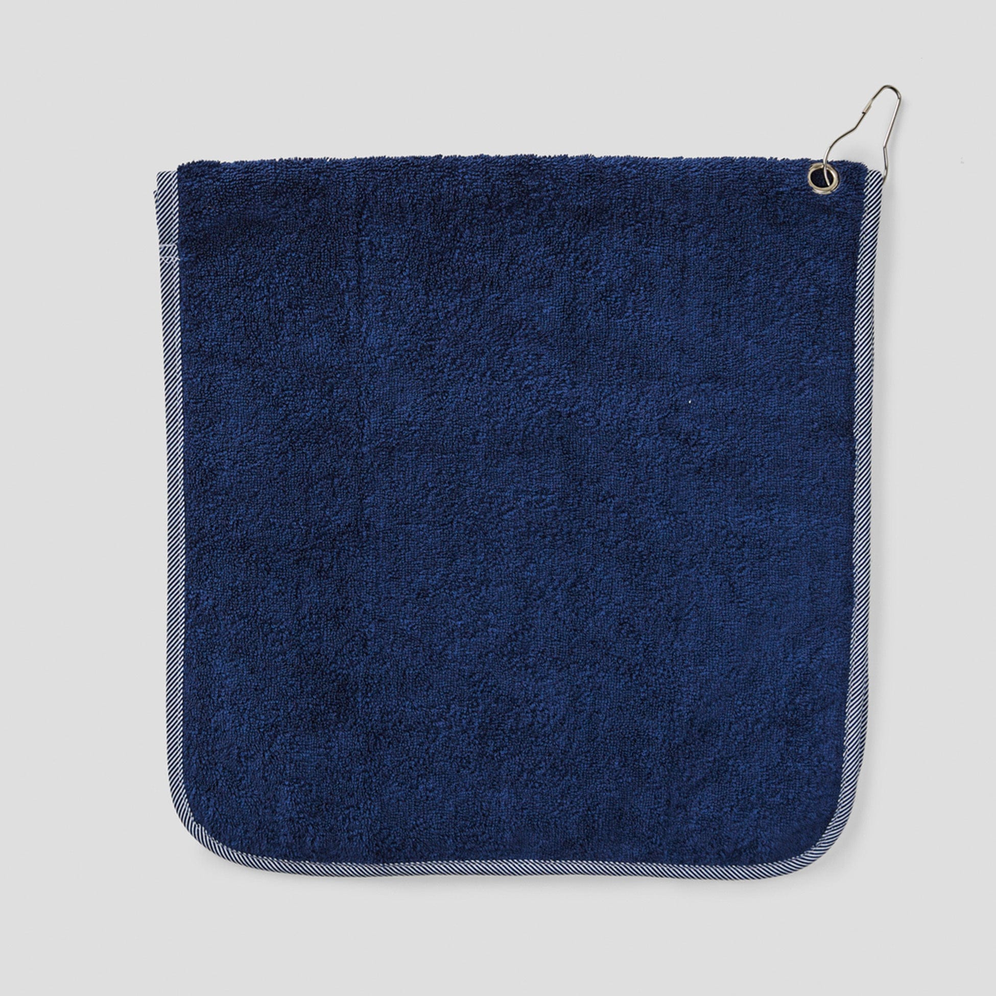 Navy Weezie towel with crossed golf clubs embroidery, folded flat